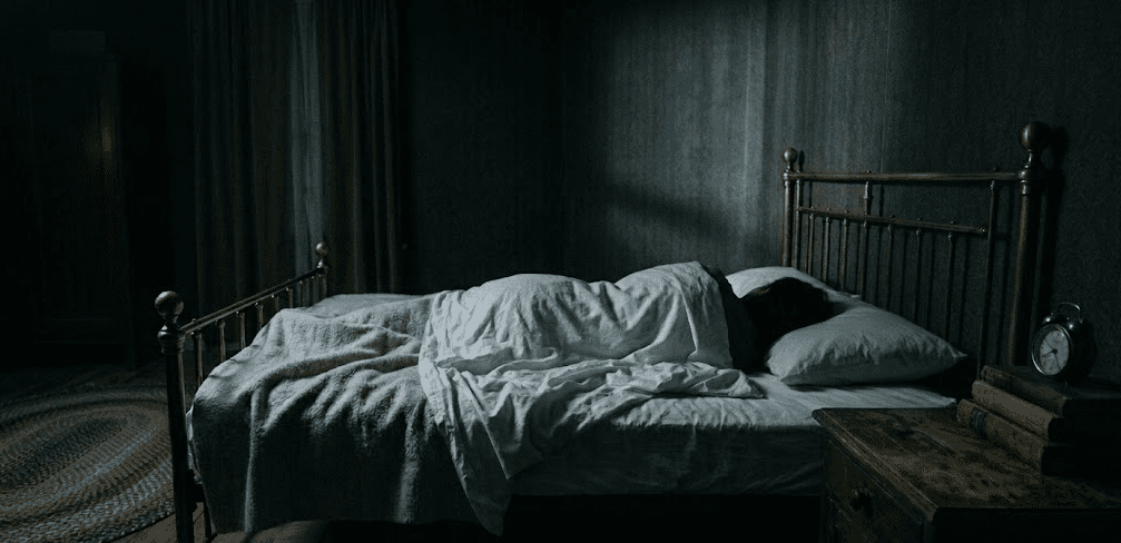 Shadow of a flying figure on the bedroom wall above a sleeping body, representing lucid dream exploration